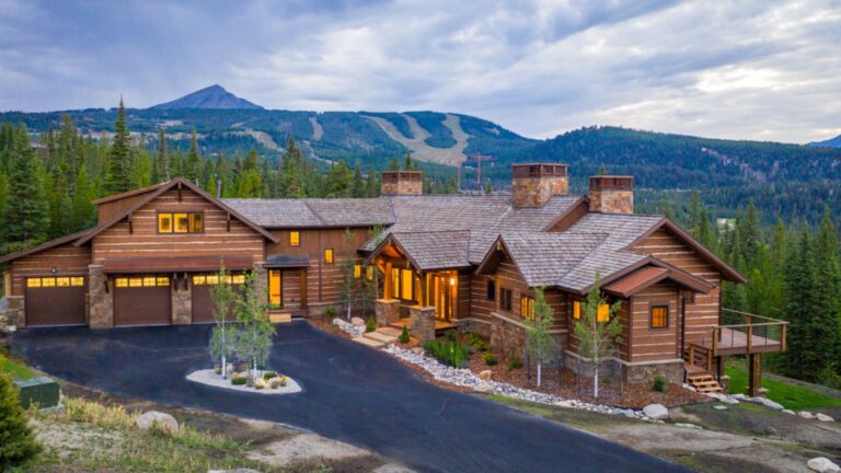 view from above of the mountain valley estate surrounded by pine trees with mountains in the background