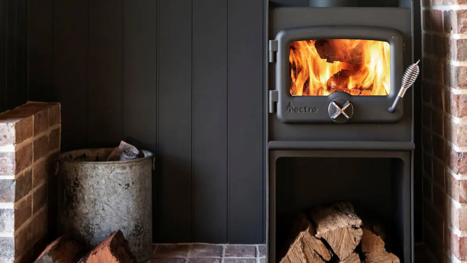 beautiful matte black fireplace with fire crackling