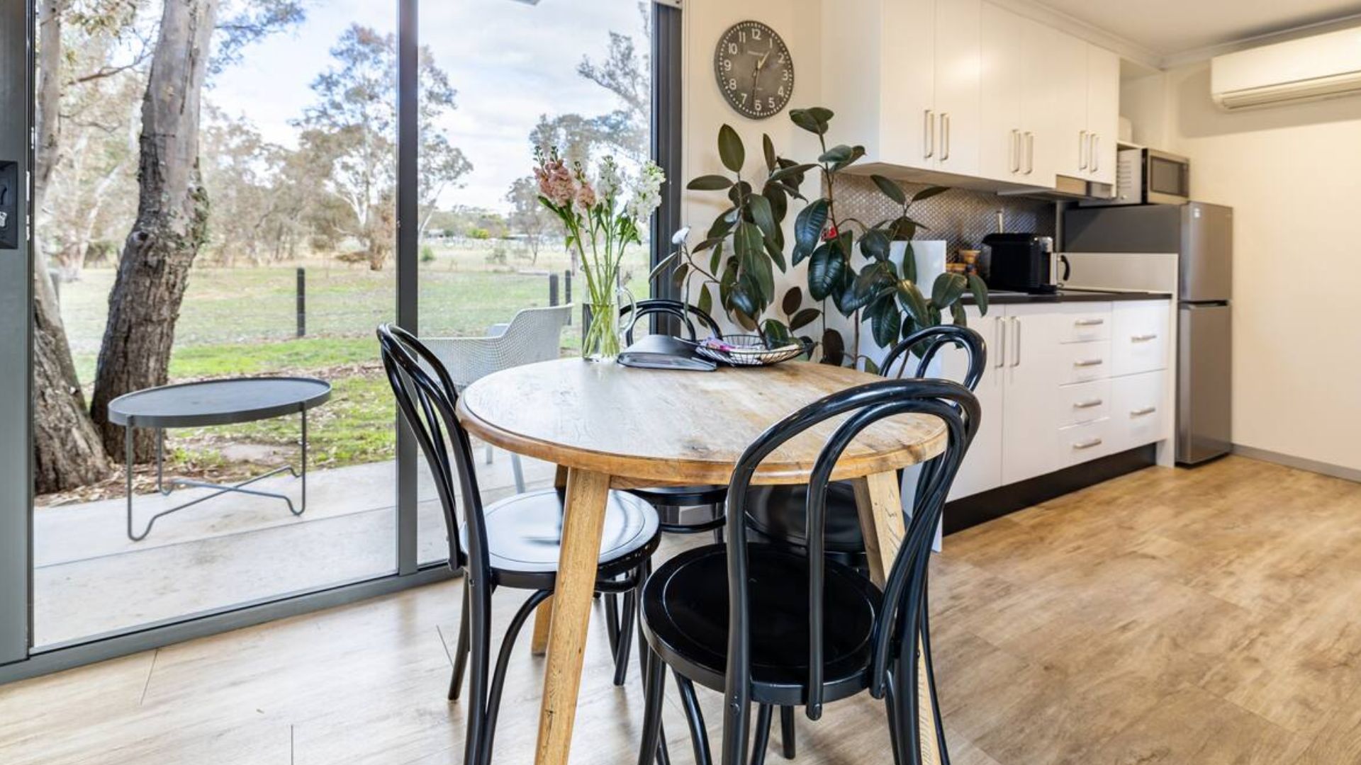 round dining table with black chairs in the middle of the room