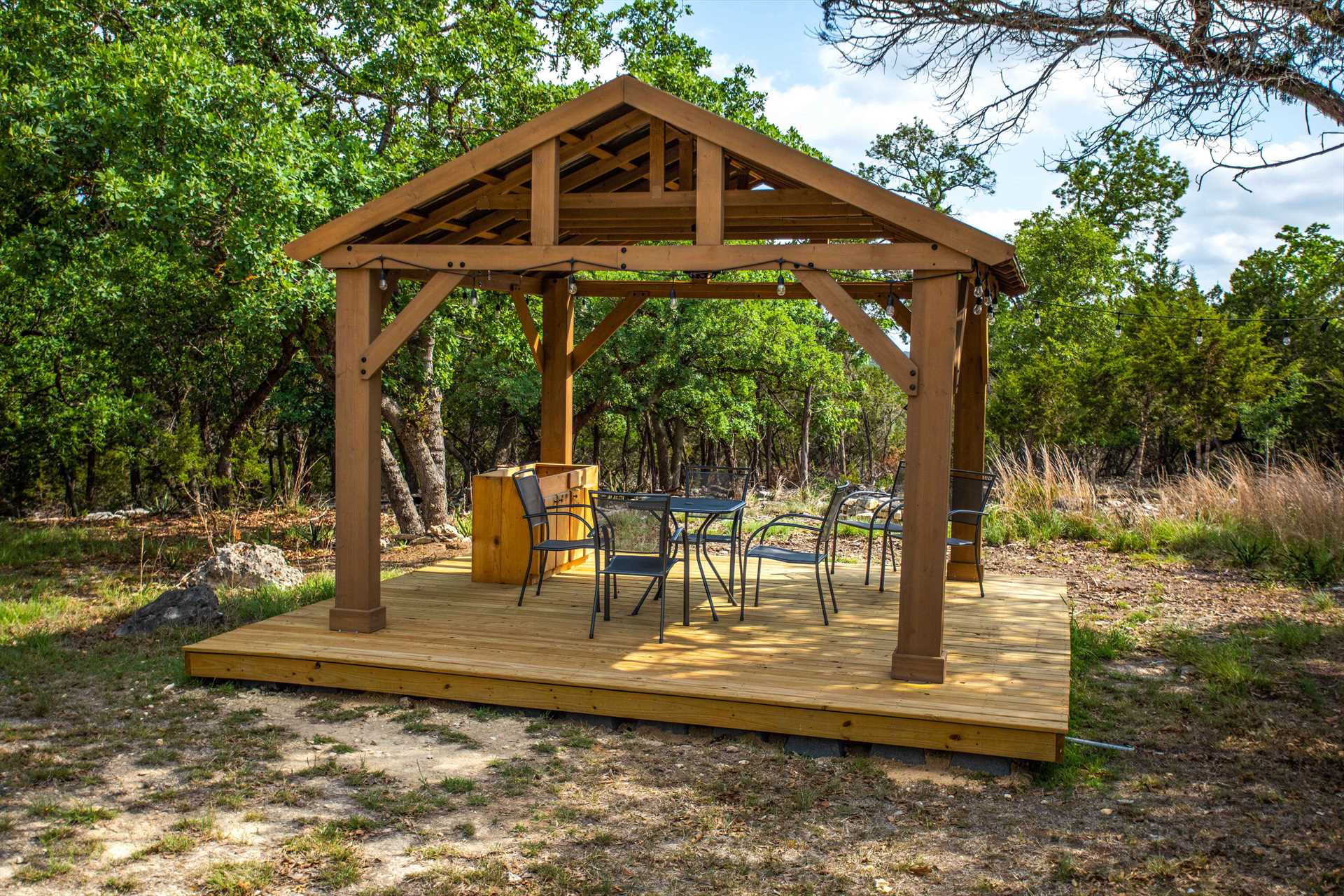 Gazebo by a cabin with a lounge area