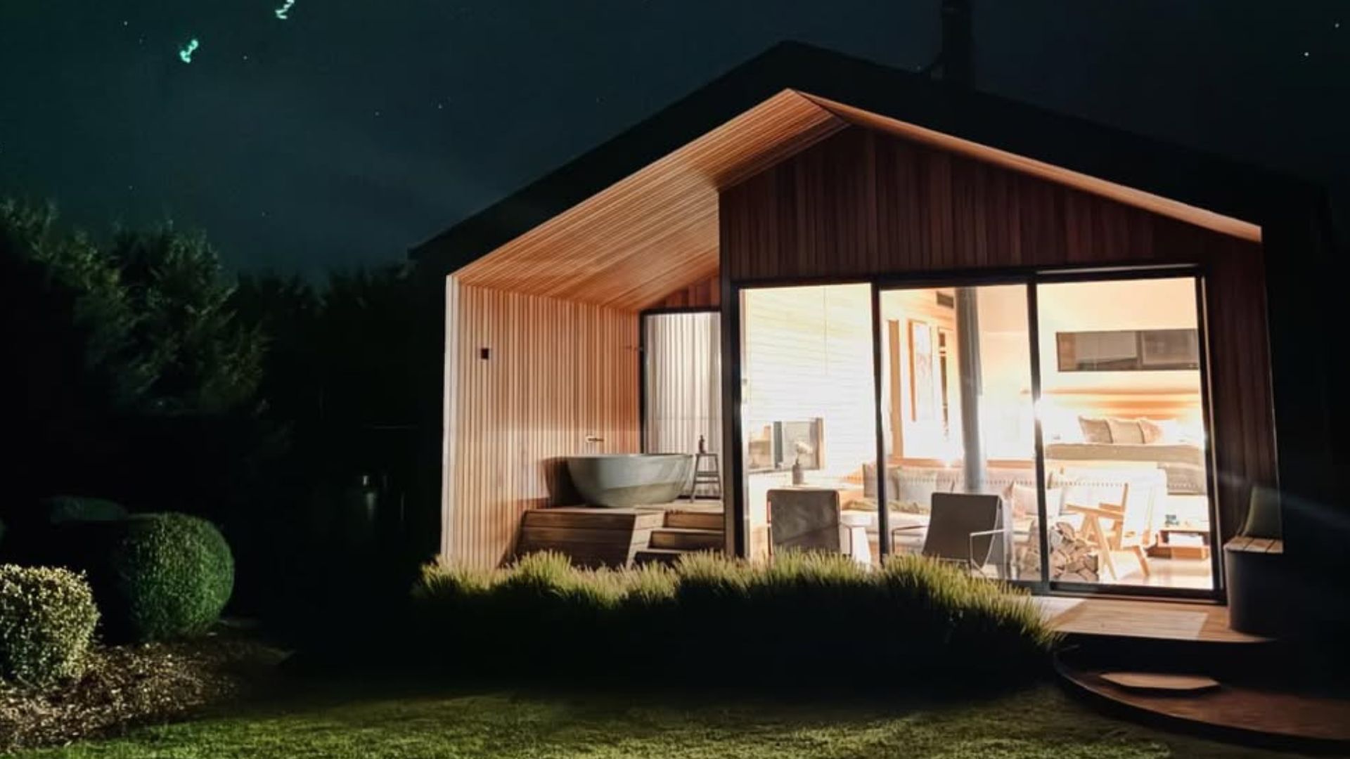 beautiful cabin at night with lights on