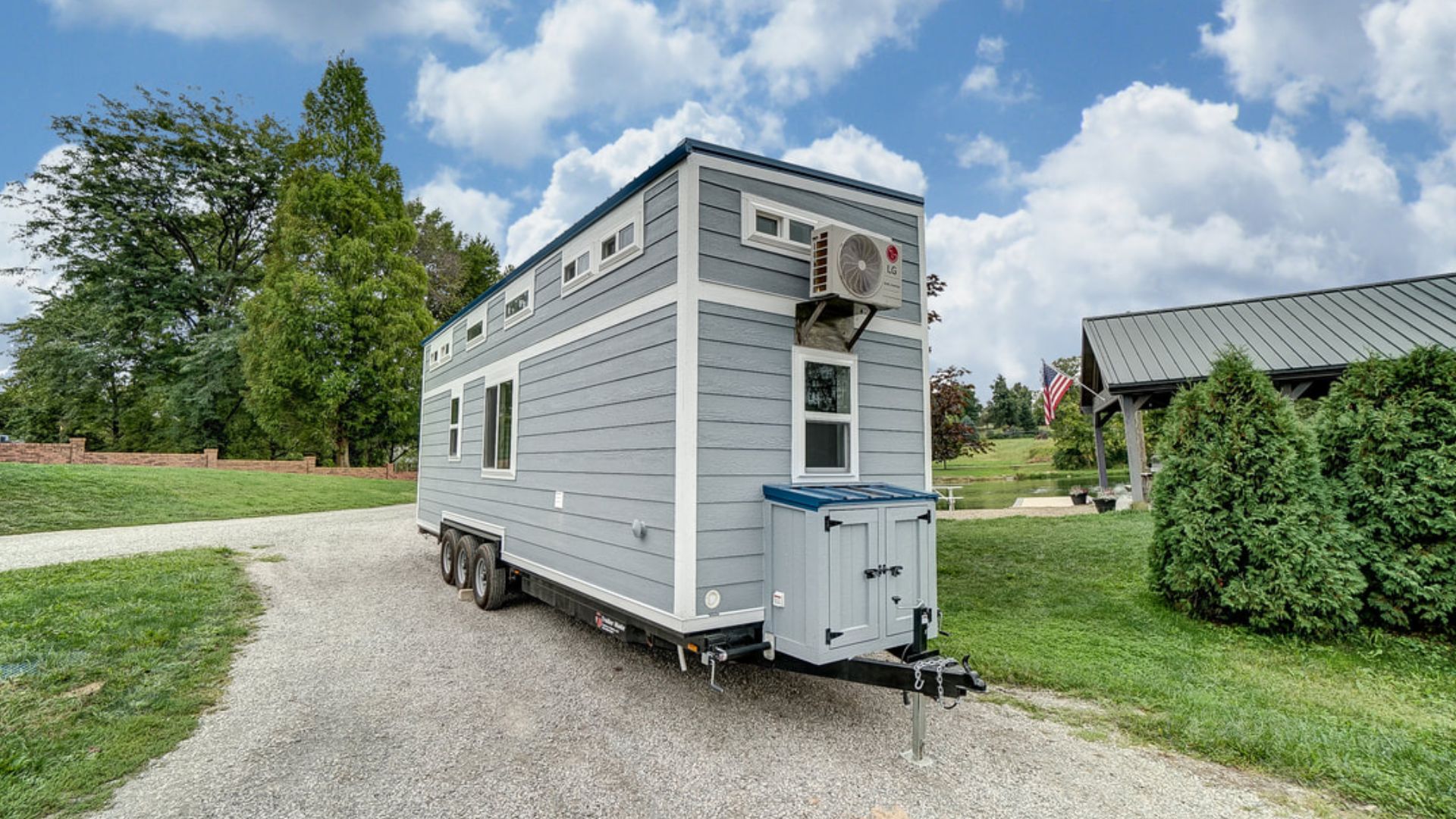 tiny house on wheels from the outside, surrounded by nature