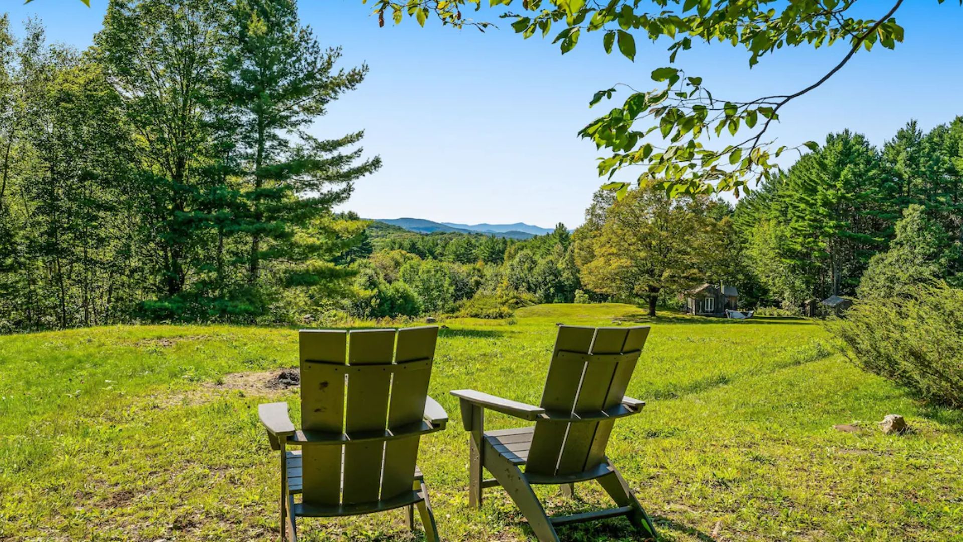 two chairs looking at a green field