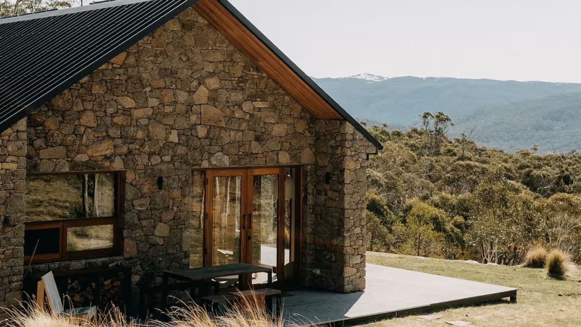 rustic stone cabin nestled in a wooded landscape, bathed in soft sunlight and surrounded by natural beauty