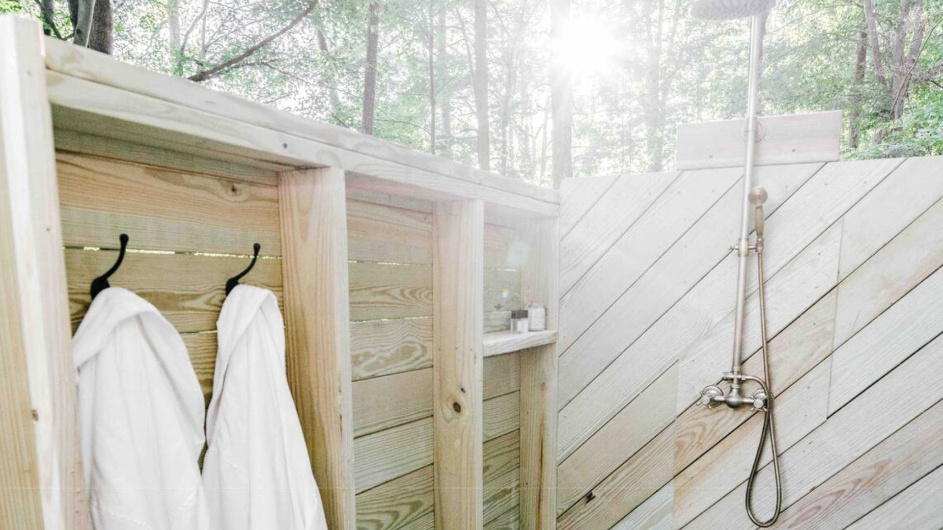 outdoor shower with two bathrobes