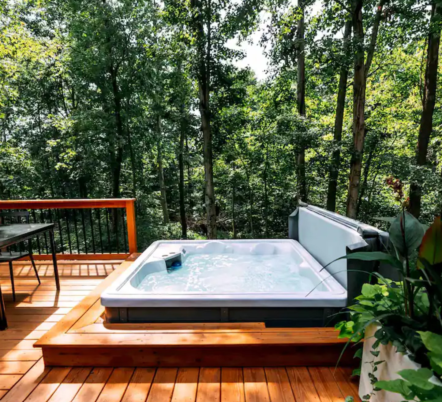 Hot tub on a porch with a tunning view