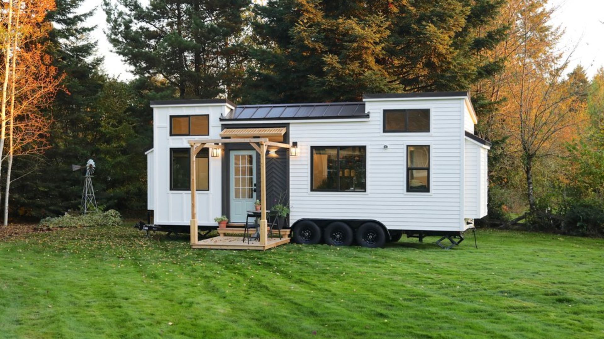 exterior of a tiny home with light blue door and a porch