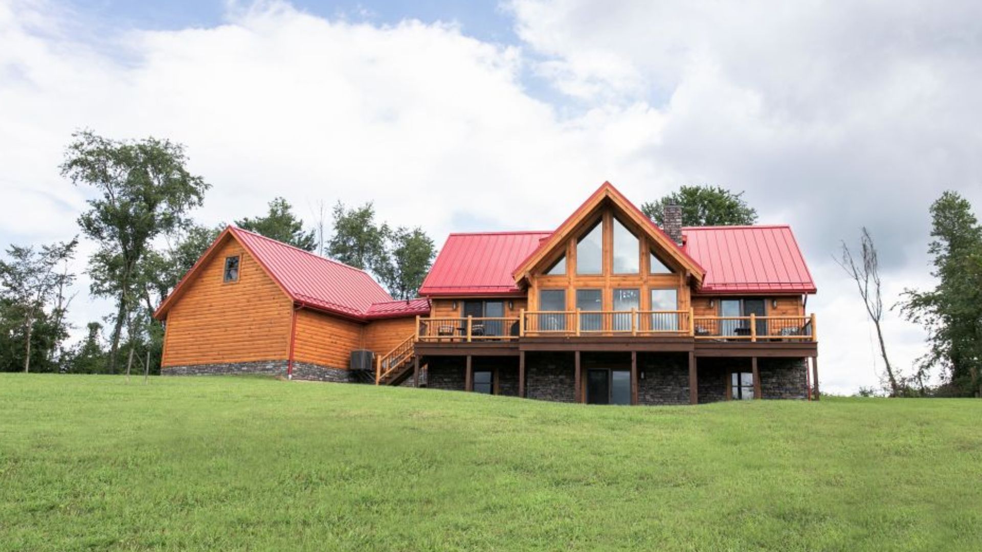 exterior of a cabin with a big land surrounding it