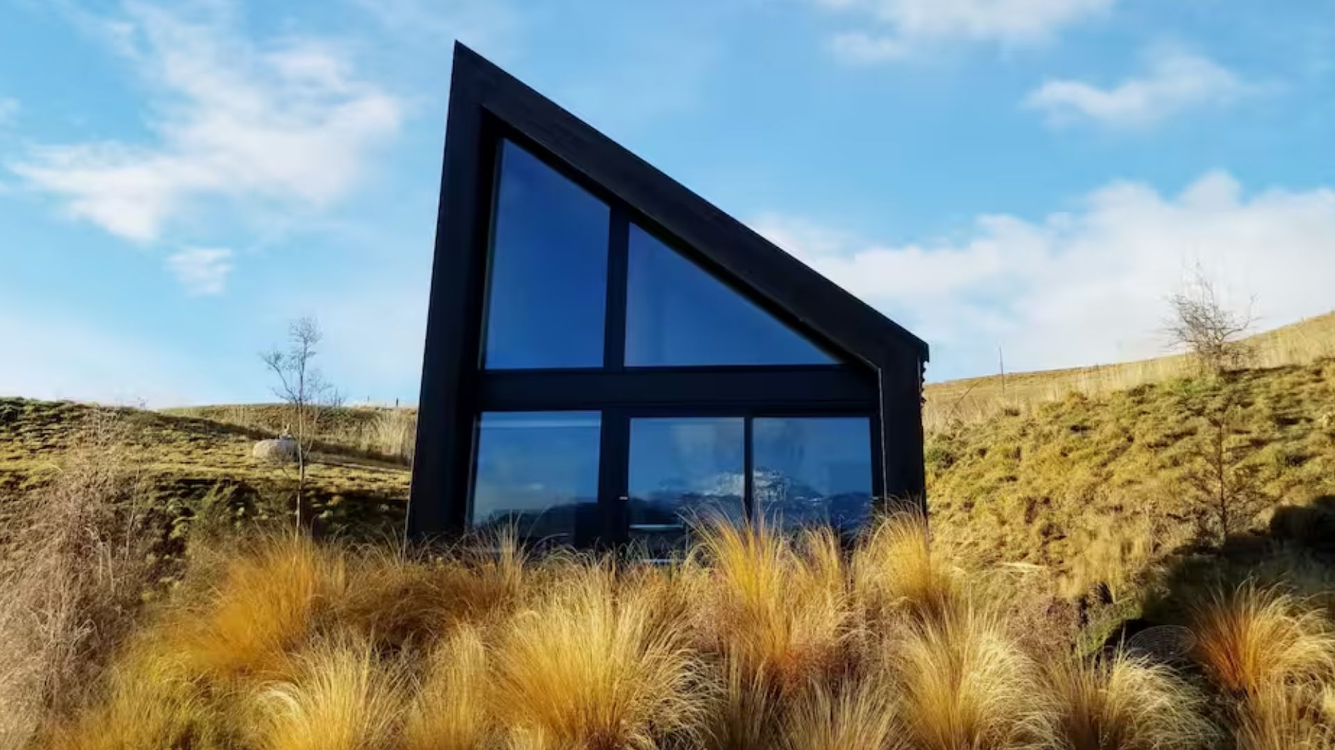 exterior of a uniquely shaped tiny home in a quiet location