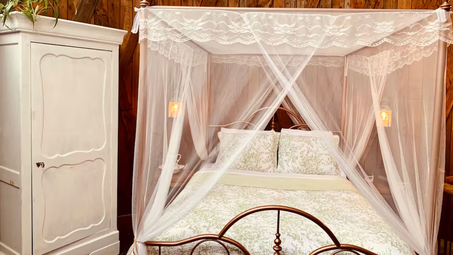 white canopy bed and a dresser