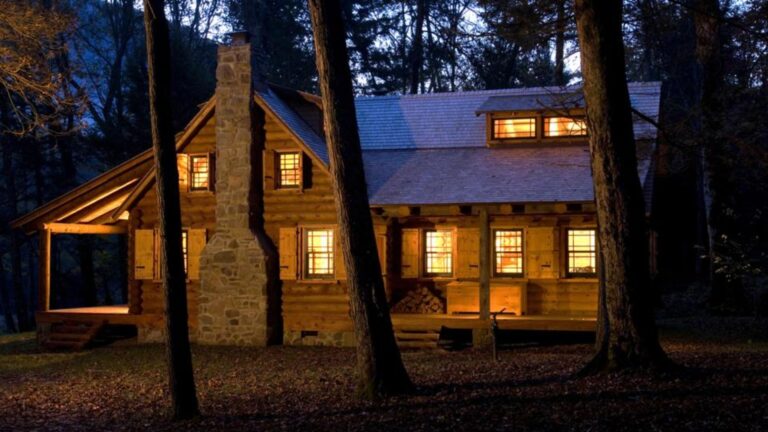 cozy cabin at night with lights on