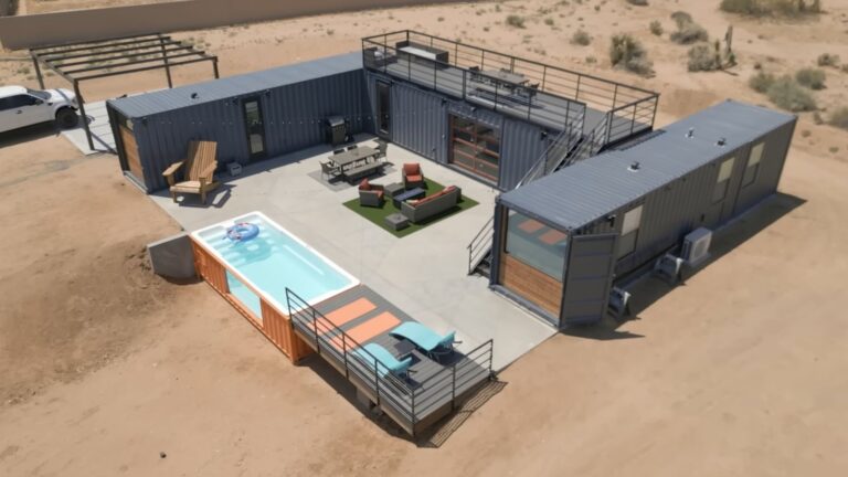 three shipping containers in anthracite arranged into a desert home with orange details and a cool swimming pool