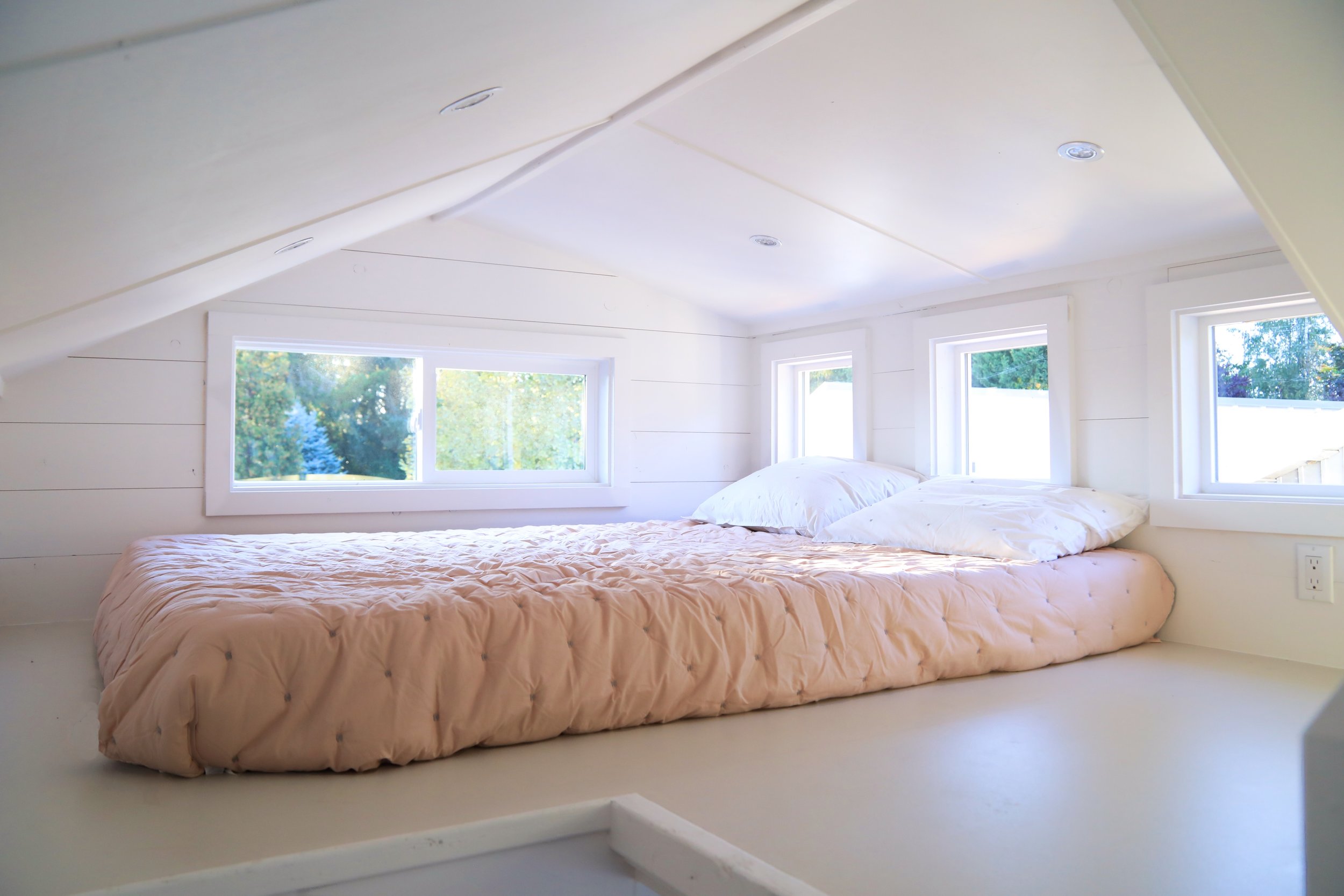 Loft with full-sized bed and windows