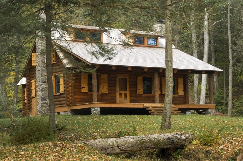 Log cabin in the woods with a big porch