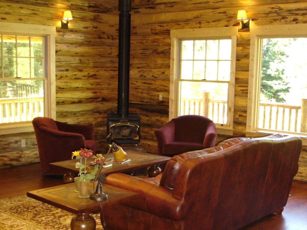 log living room with leather couch, fire place and wooden coffee table