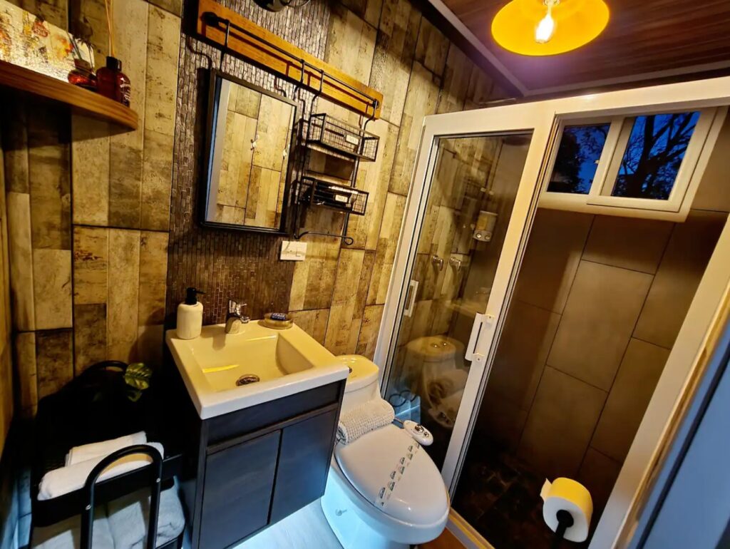 Luxurious bathroom in container home with brown tiles