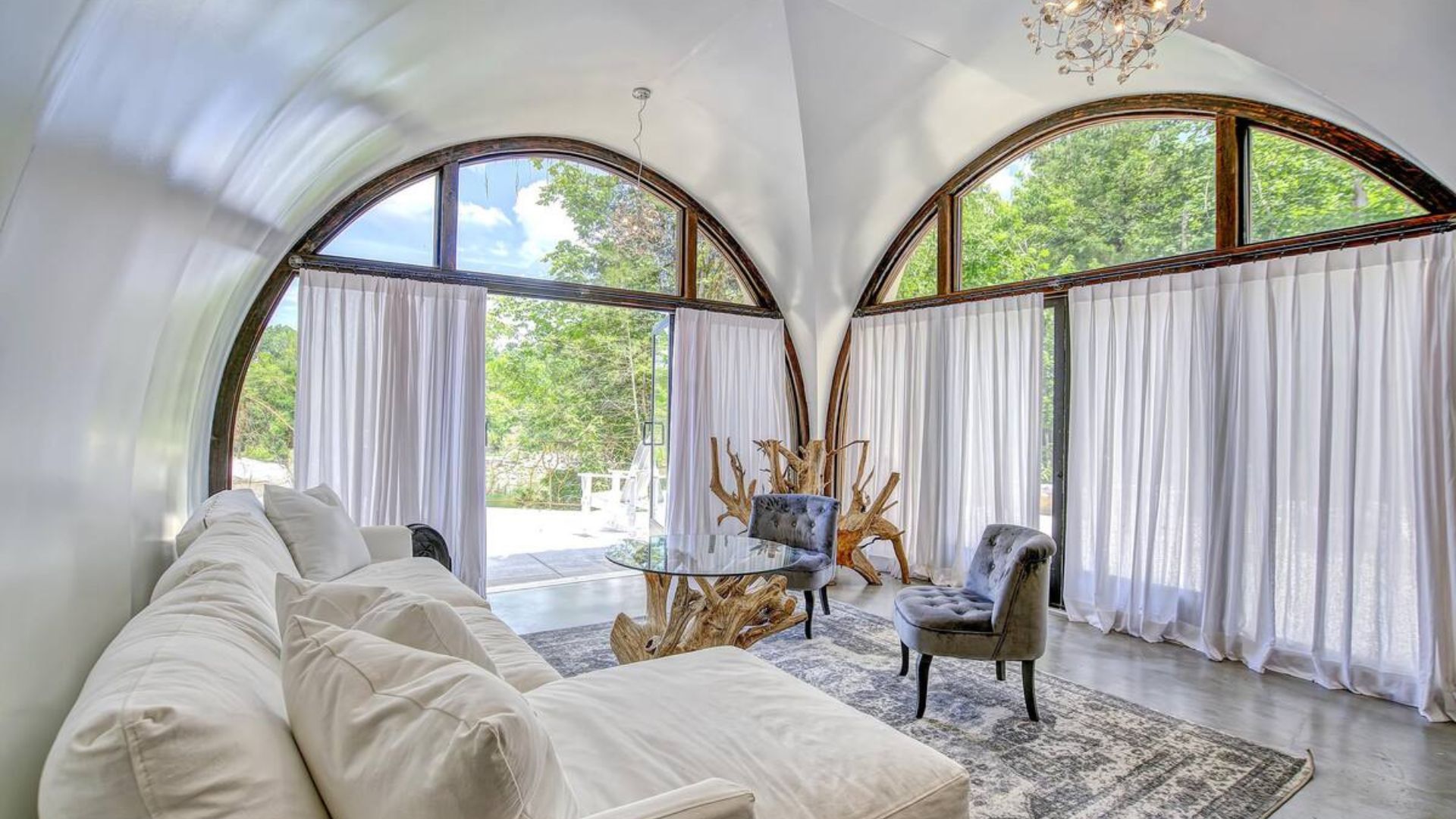 airy living room with white curtains on the windows