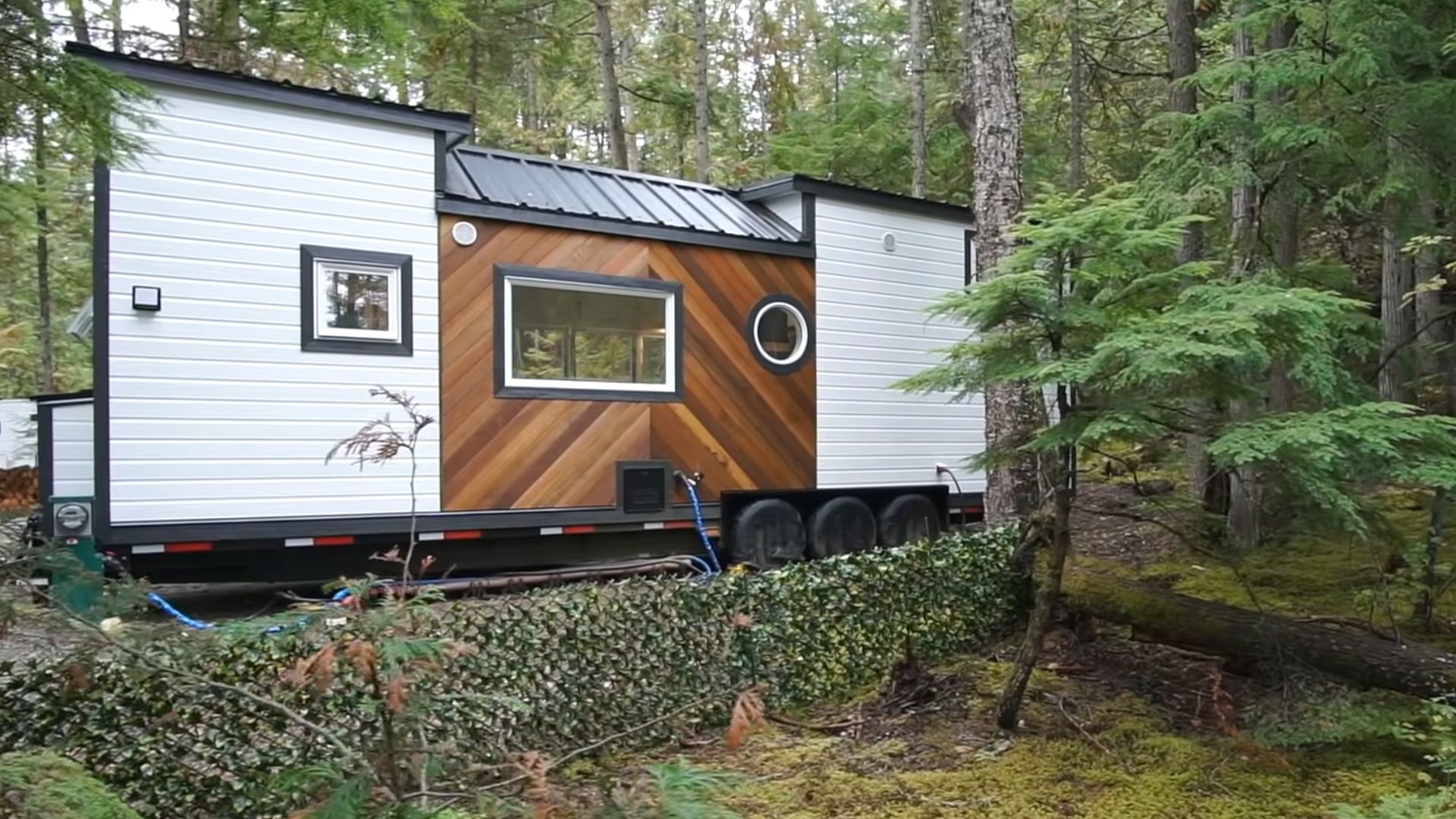 exterior of a tiny house on wheels with brown and white walls