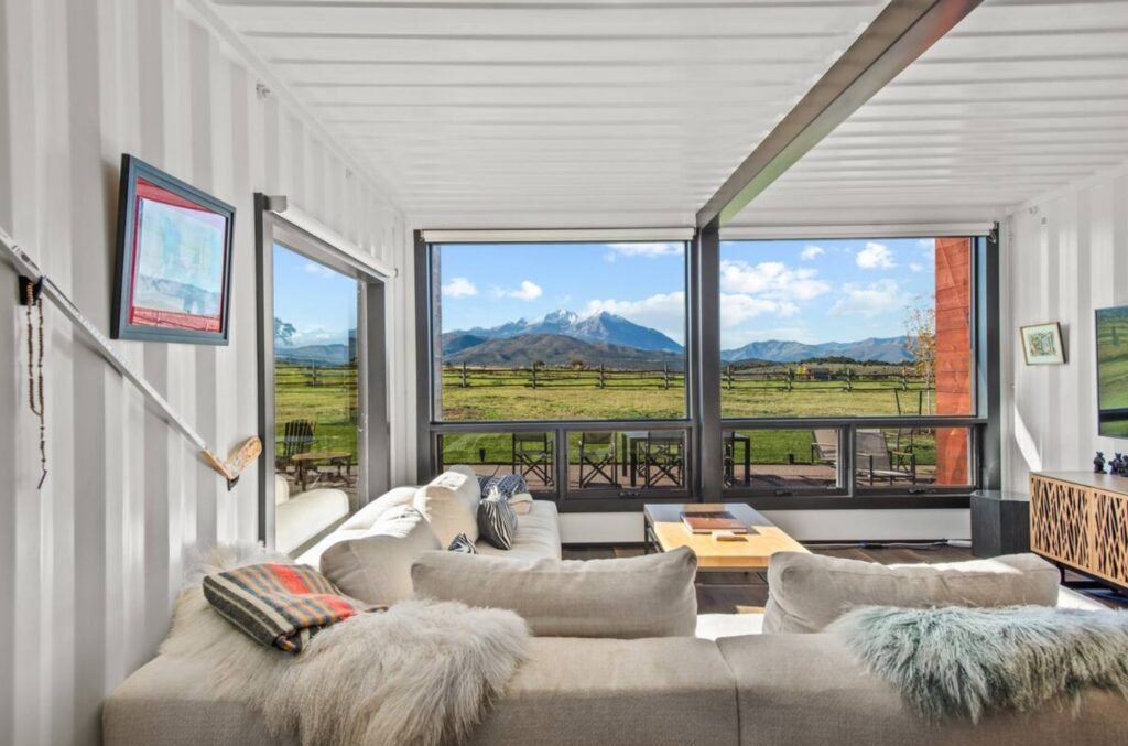 Rustic living room in container home with a view on the fields