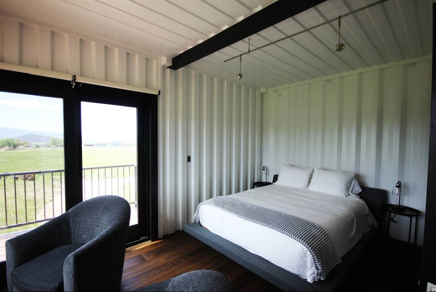 Second bedroom with a full-sized bed and a balcony