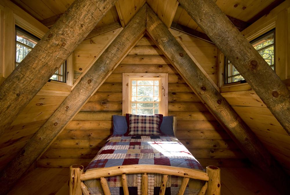 Single bed in a cabin with patchwork bedding