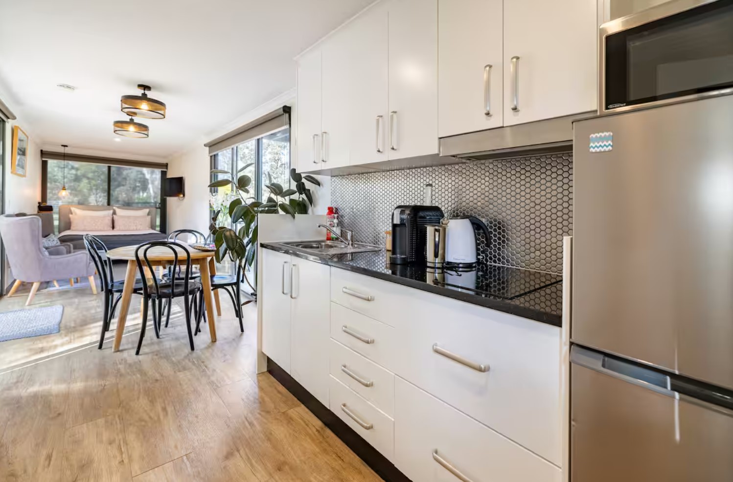 Sleek full-sized kitchen with white cabinets