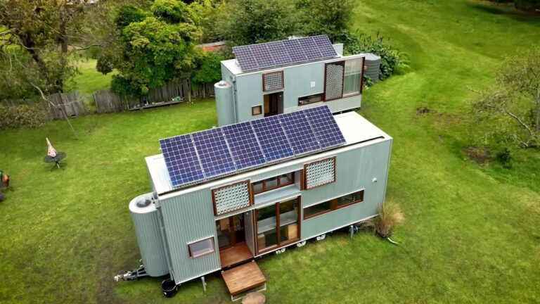 exterior of two tiny houses surrounded by a big land