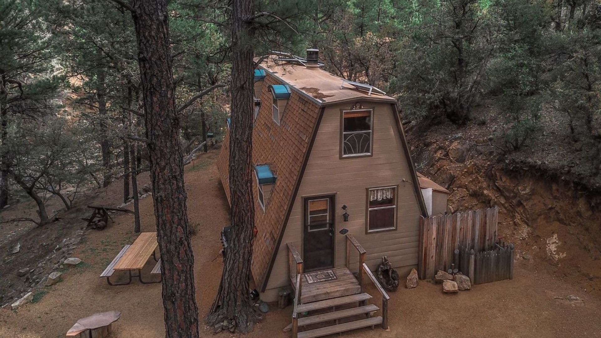 exterior of an a-frame cabin in the woods