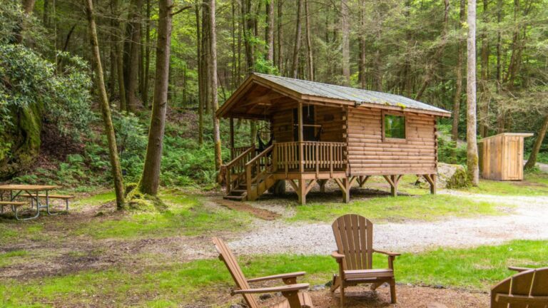 Wooden cabin with porch next to a creek