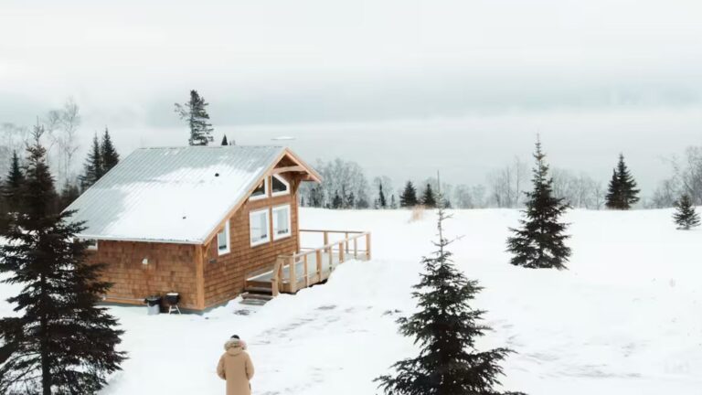 wooden cabin by the lake in winter