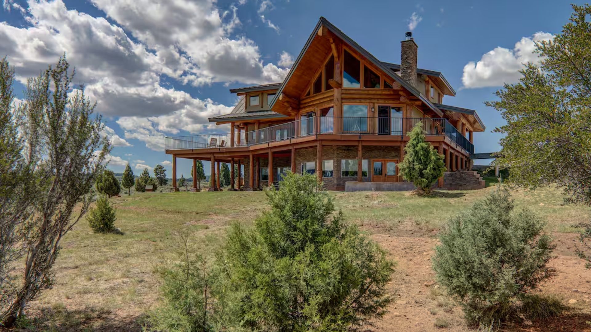 exterior of a log cabin with nature surrounding