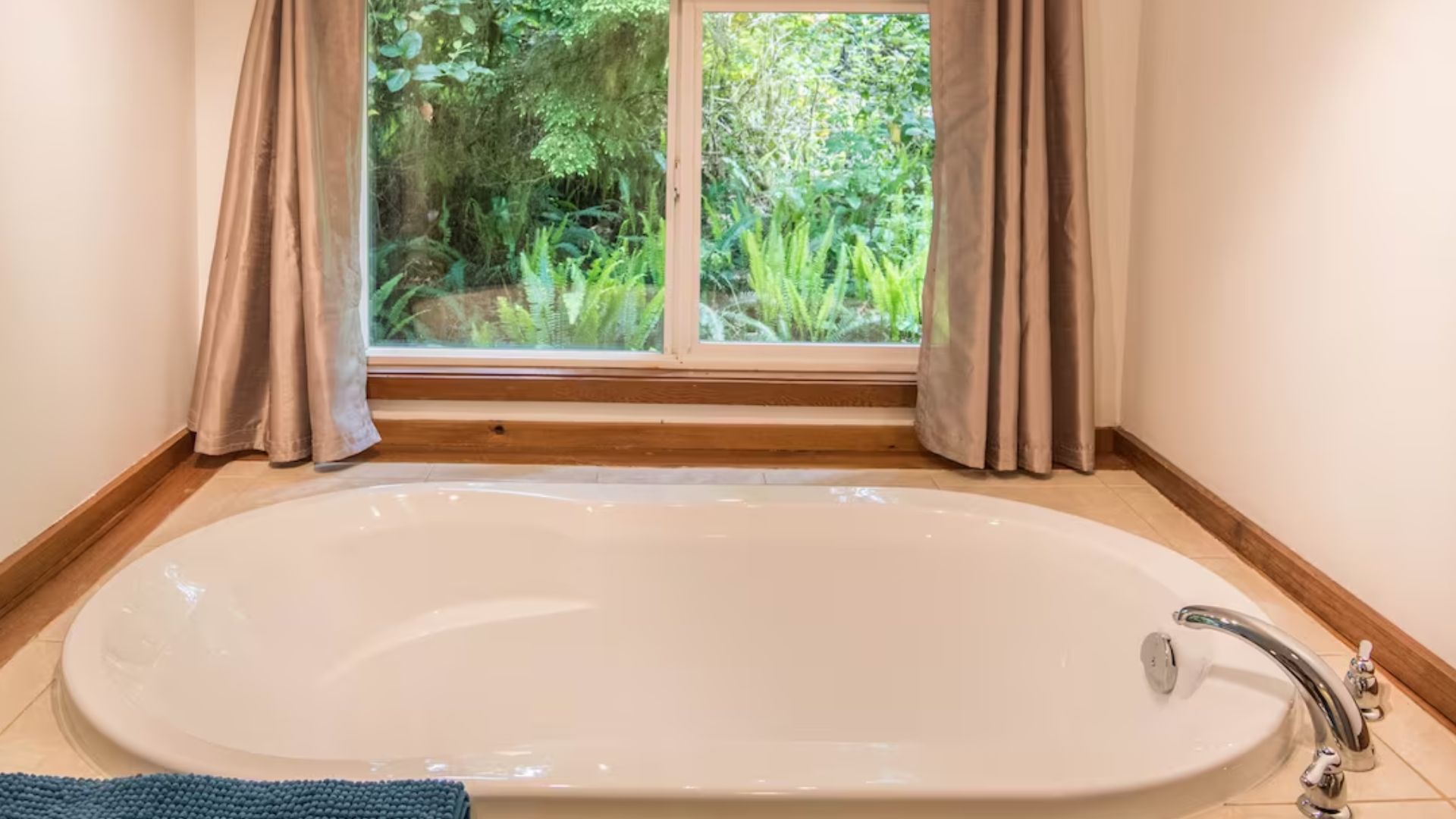 deep soak-in tub next to a window