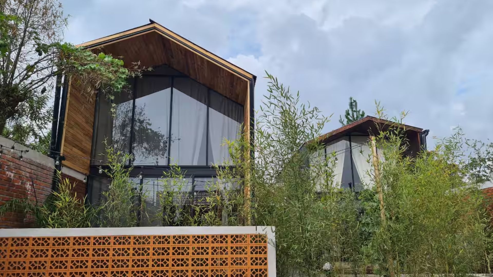 exterior of a tall container home with floor to ceiling windows