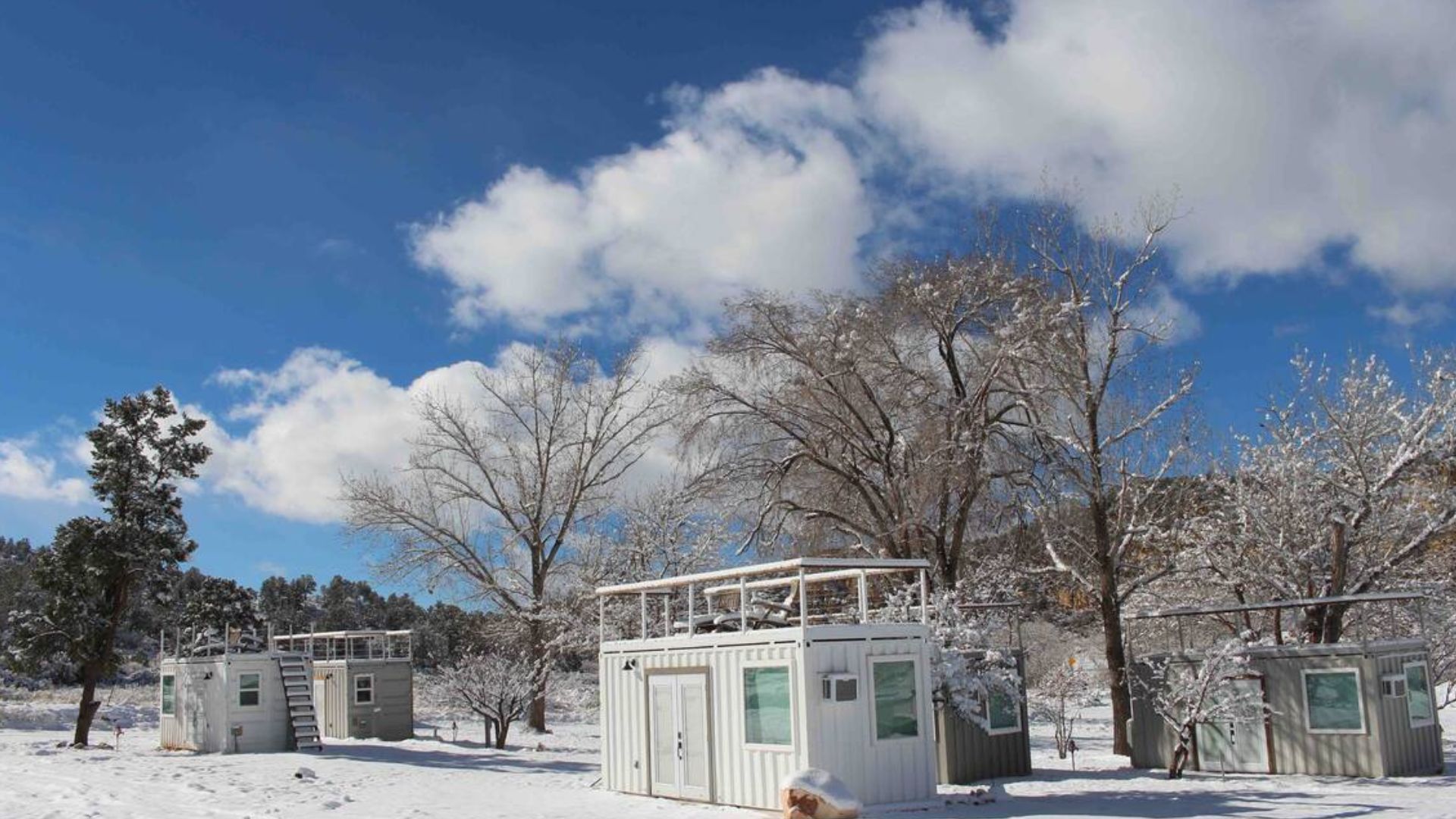 exterior of a white container with a roof terrace in winter time