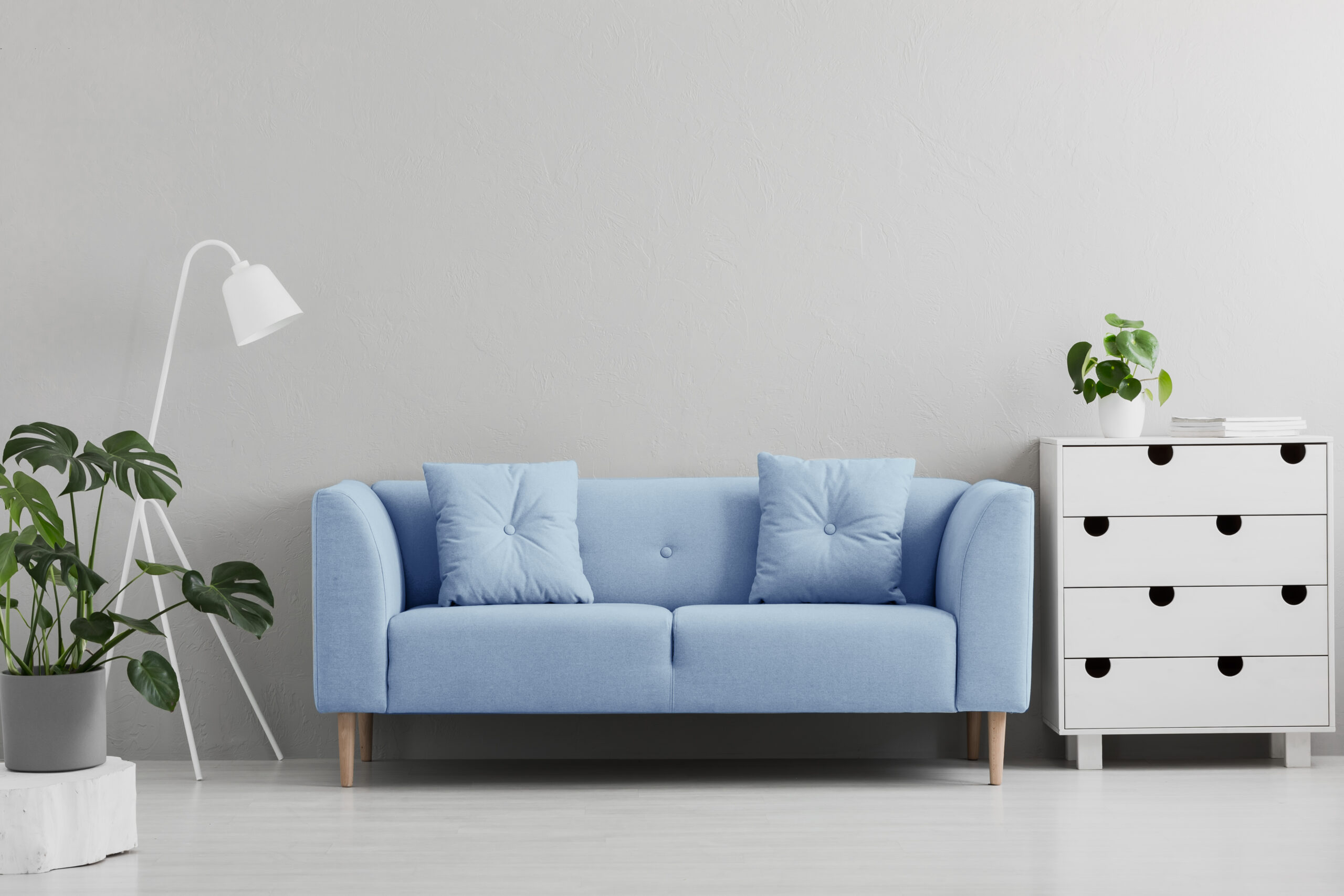 white living room with a baby blue couch and white furniture