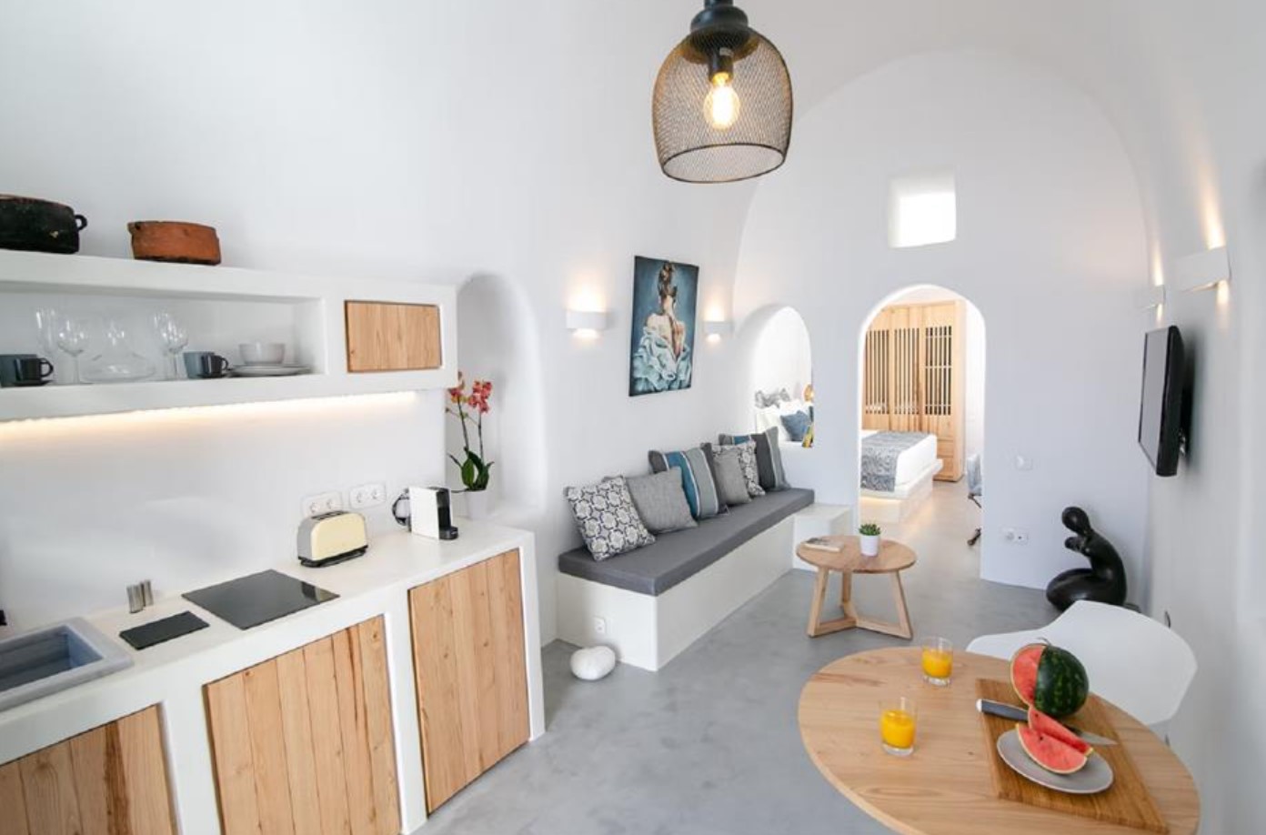 White modern kitchen in cave home with curved walls