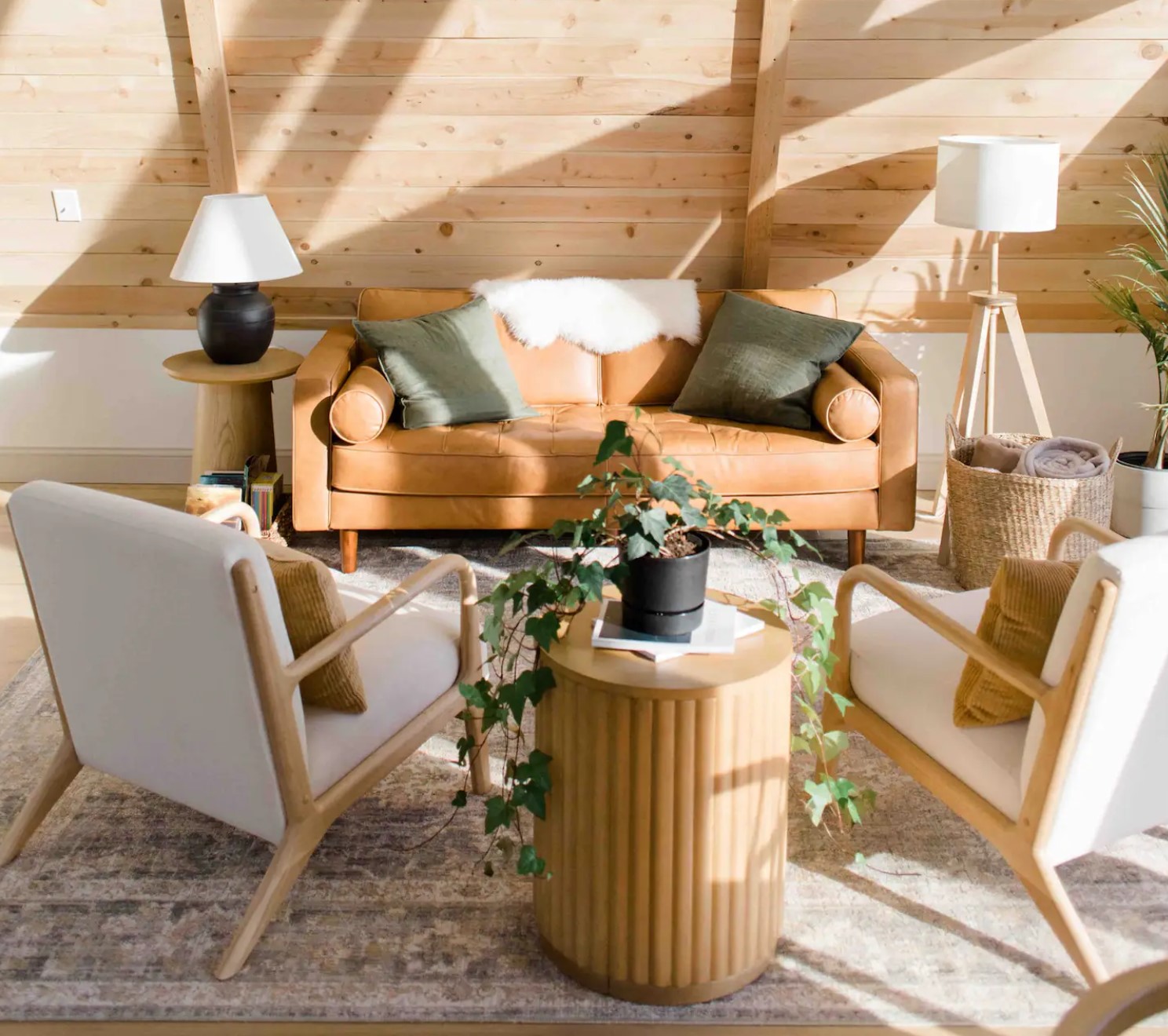 Wooden living room with an orange leather couch and two chairs