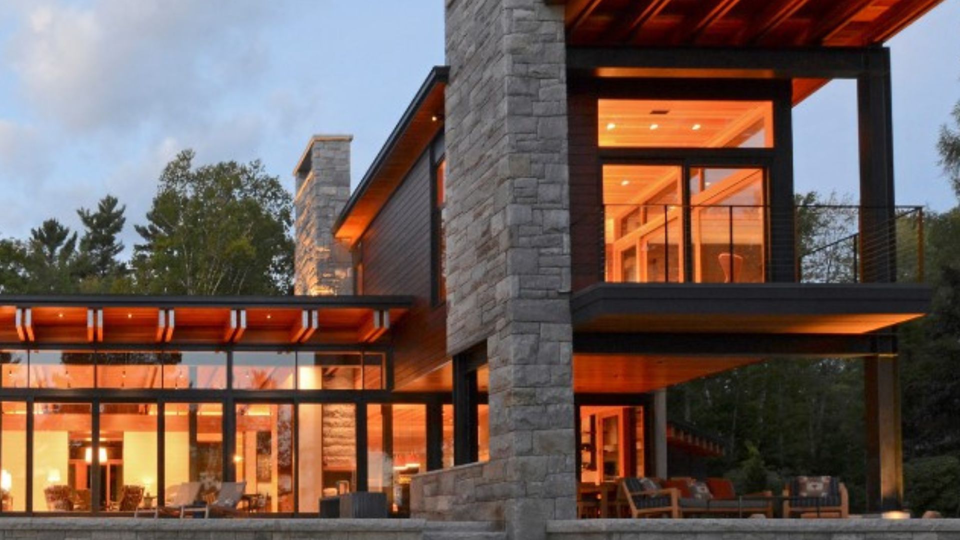 modern house with glass wall overlooking the lake