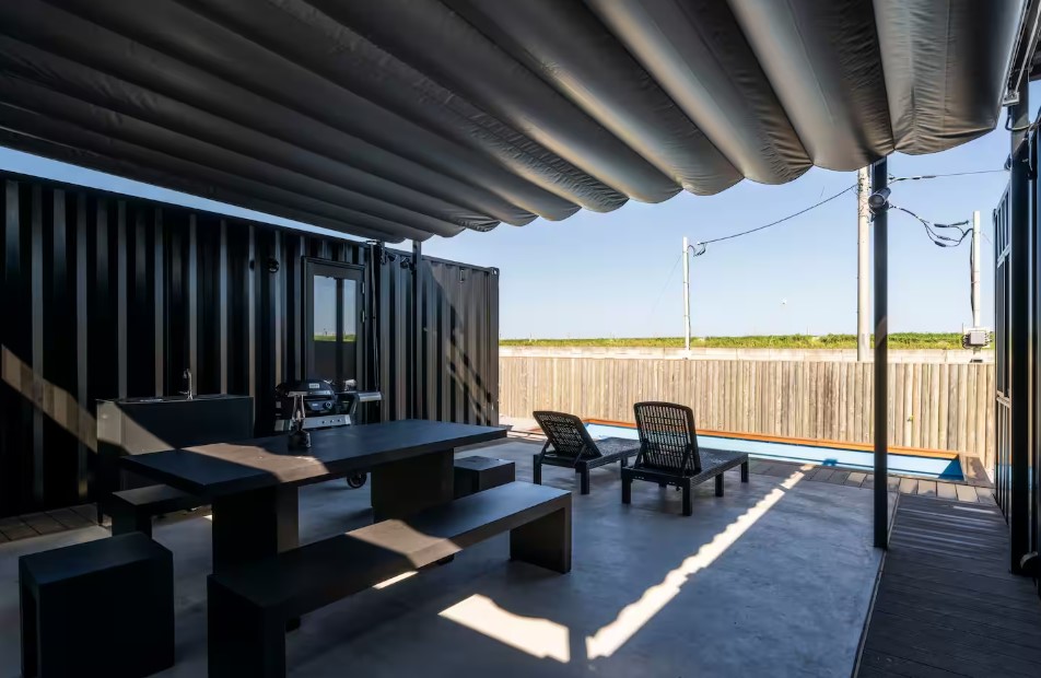 backyard with a grill, black dining table and a pool