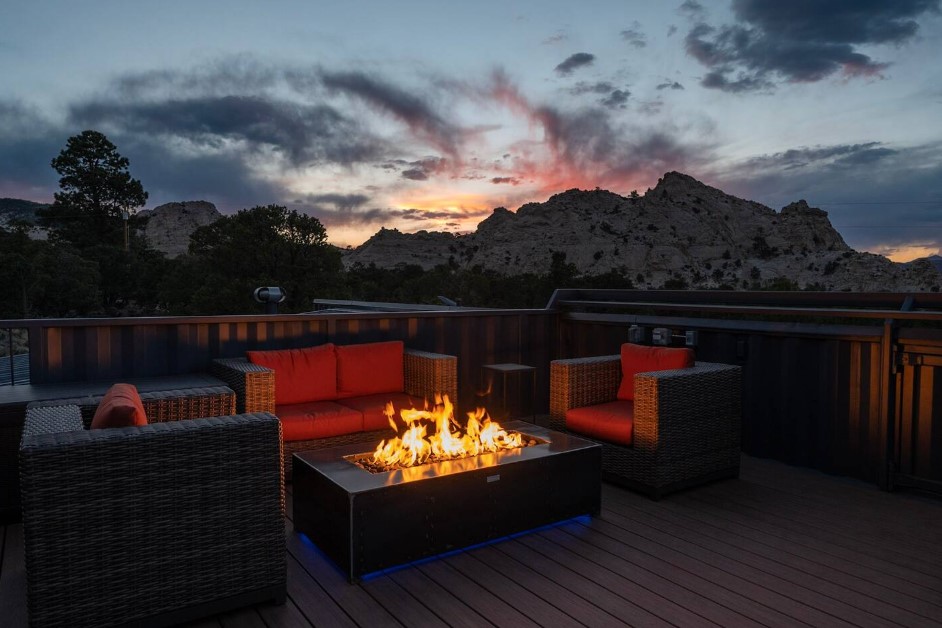 balcony with a fire table, red cushioned sitting area