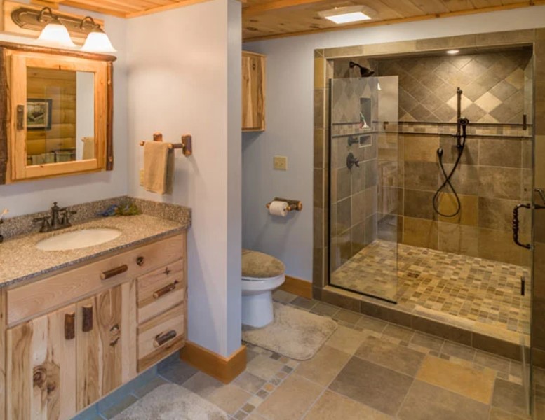 bathroom with a spacious shower, wooden cabinets and a mirror above