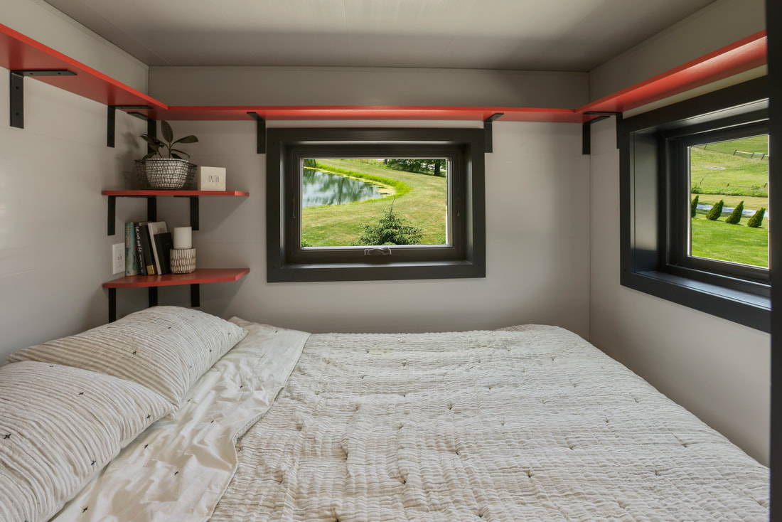 bedroom with two windows and red shelves