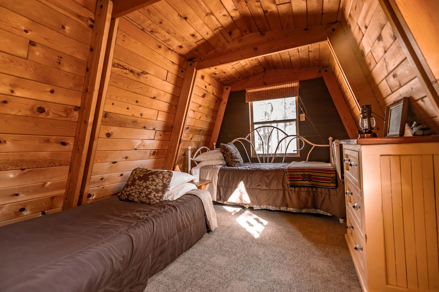 bedroom with one couch and one bed, brown cabinet