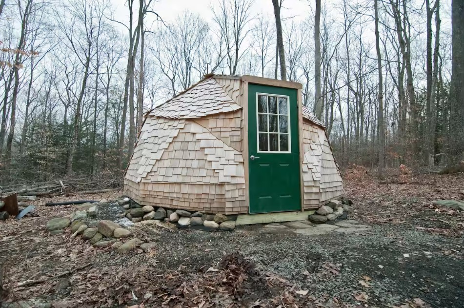 round wooden home in the woods