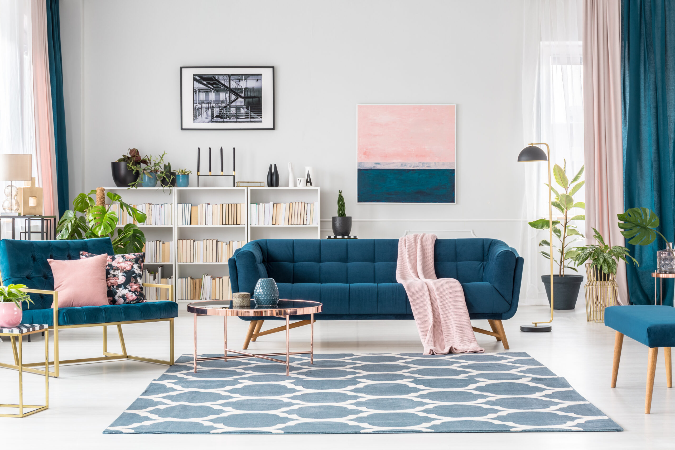 blue and pink living room with a bookshelf and lounge area