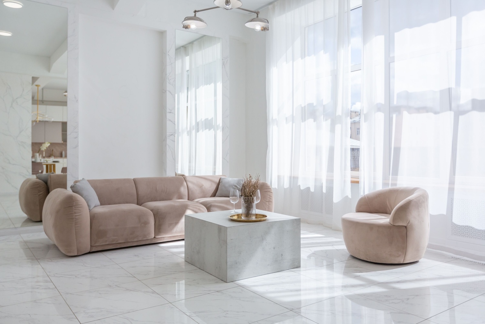 living room with beige couch and a beige sofa, rectangular light gray table, white curtains