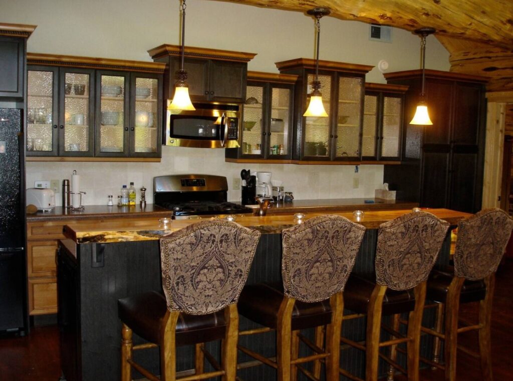 Dark and light wooden kitchen with light fixture above island