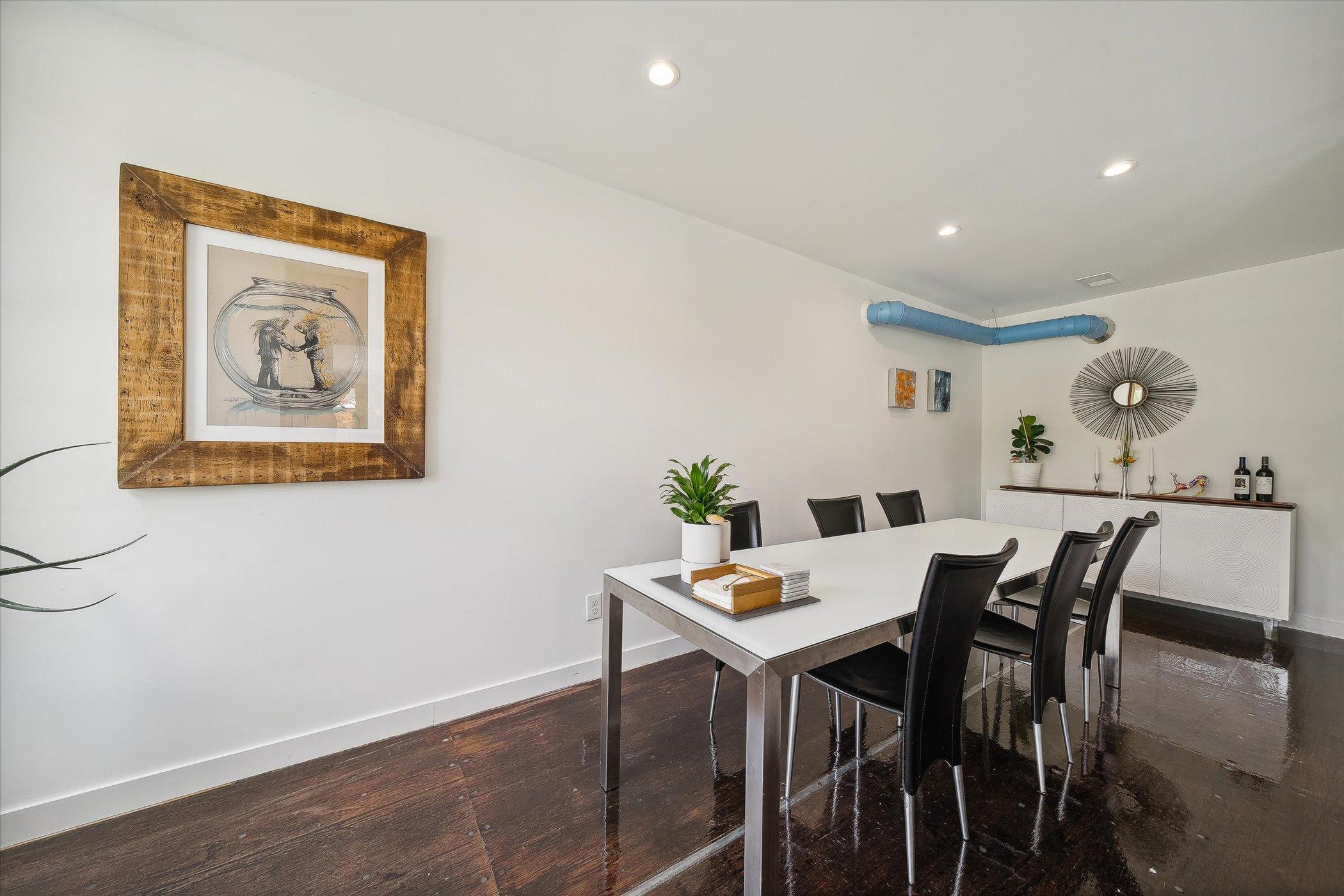 dining room with a long dining table accompanied by black chairs