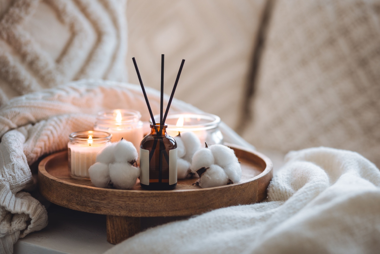 wooden tray with candles and scented sticks and cottons swabs