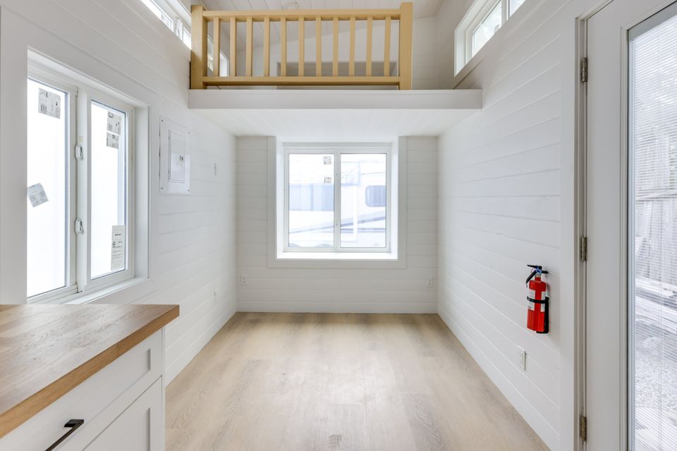 empty living room with white walls and big windows